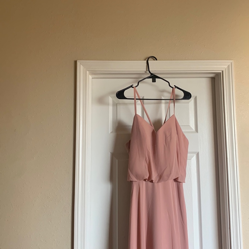 Floor length blush colored strappy bridesmaid dress